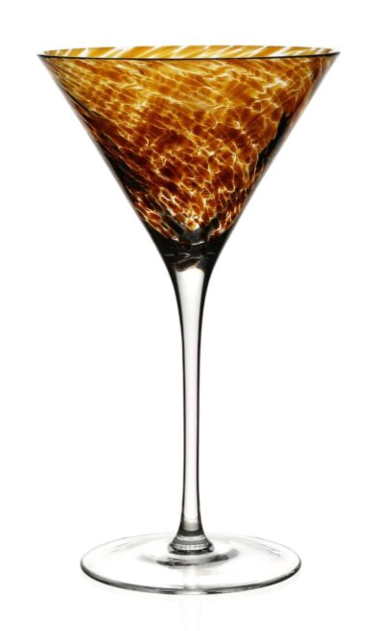 A Vanessa Tortoise Collection martini glass by William Yeoward Crystal features a brown and gold marbled bowl that creates an optical illusion, set against a white background.