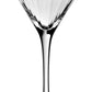 The Corinne Collection martini glass by William Yeoward Crystal features a long stem, wide conical bowl, and elegant vertical optic lines, displayed empty against a plain white background.