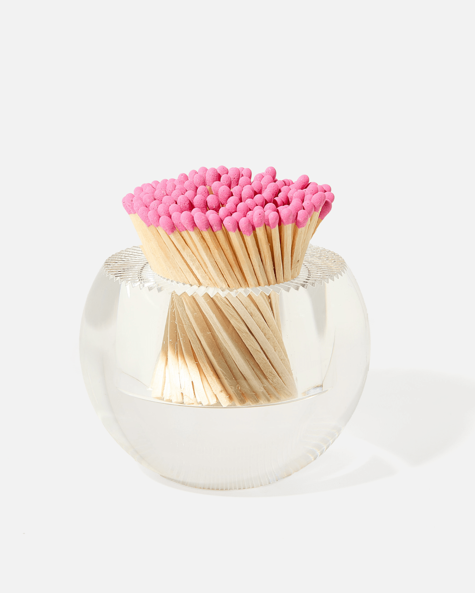 The Acrylic Match Striker Collection by Tart by Taylor adds charm to your coffee table, with pink-tipped matches artfully displayed in a clear vessel for a stylish accent.