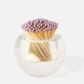 The Tart by Taylor Acrylic Match Striker Collection features a round glass holder with purple-tipped matches, offering a chic coffee table accent and an ideal way to display your matches.