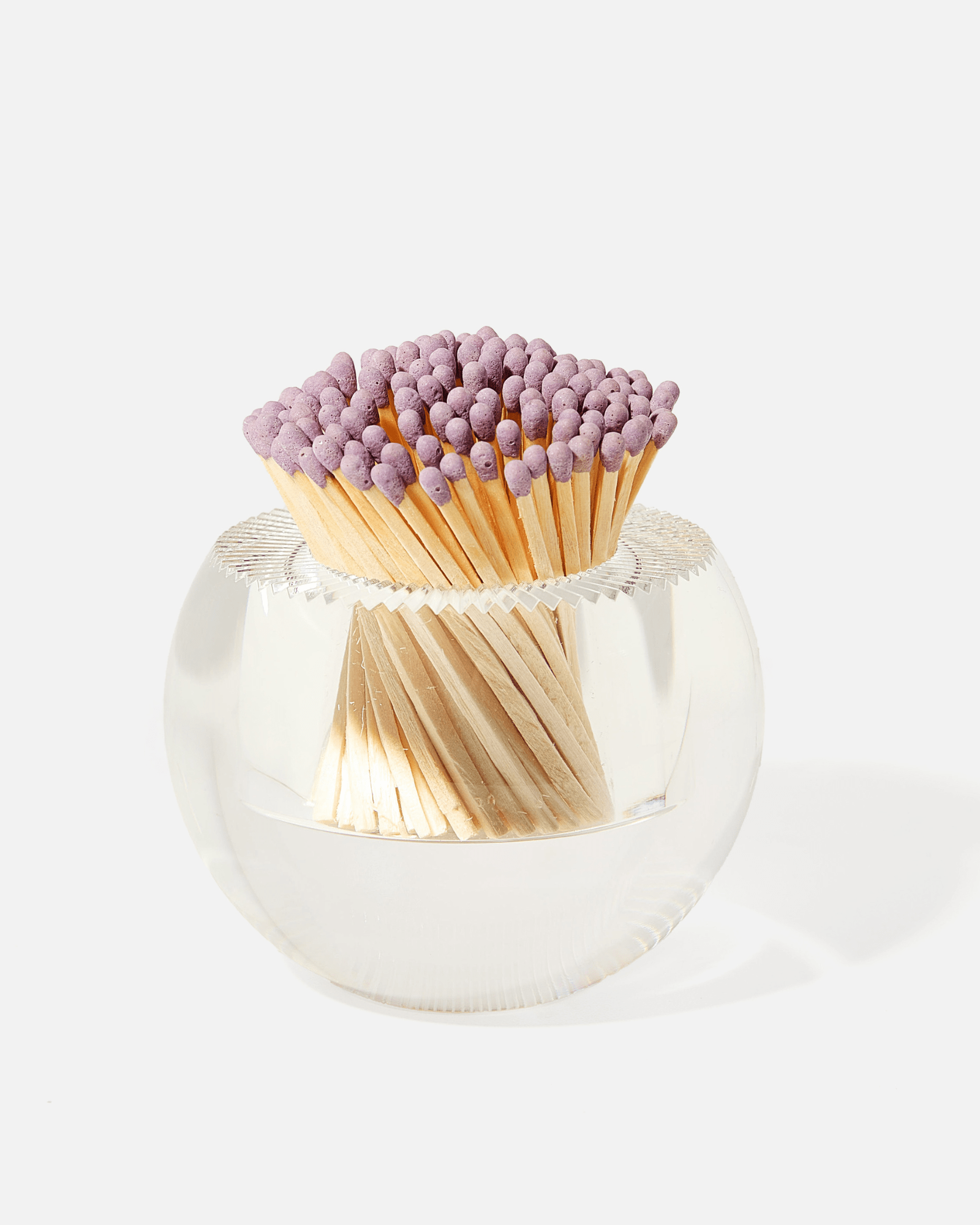 The Tart by Taylor Acrylic Match Striker Collection features a round glass holder with purple-tipped matches, offering a chic coffee table accent and an ideal way to display your matches.