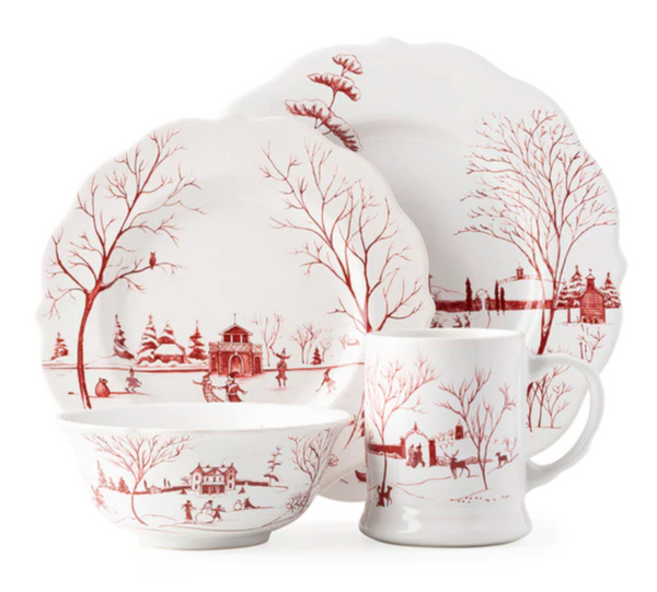 The Juliska Country Estate Winter Frolic Ruby Collection by Juliska includes a set of dinnerware with festive ruby winter scenes, featuring two ceramic plates, a bowl, and a mug.