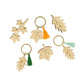 Five Liberty Fall Velvet Bows Crackers by Meri Meri, with velvet bows and vibrant designs, arranged on a white background—ideal as festive fall table decor; two crackers are shown without bows.
