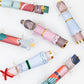 Meri Meri Nutcracker Ballet Crackers—six festive, colorful party crackers featuring nutcracker and mouse characters—are arranged on a white background. A charming addition to your holiday collection.