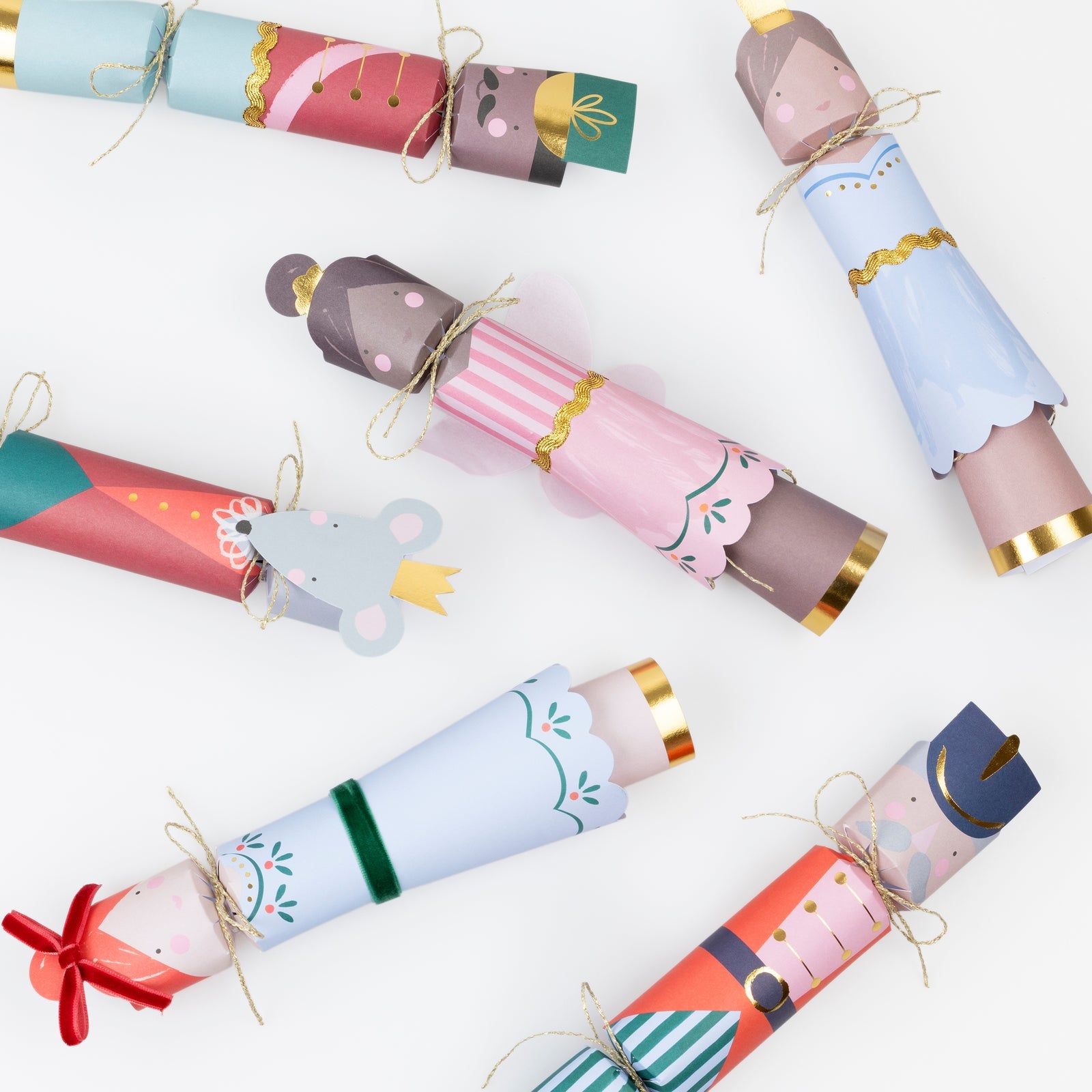 Meri Meri Nutcracker Ballet Crackers—six festive, colorful party crackers featuring nutcracker and mouse characters—are arranged on a white background. A charming addition to your holiday collection.