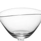 The Simon Pearce Barre Bowl from the Barre Bowl Collection is a clear glass bowl with an asymmetrical wave design, featuring a smooth, slightly curved rim labeled "Medium" at the bottom.