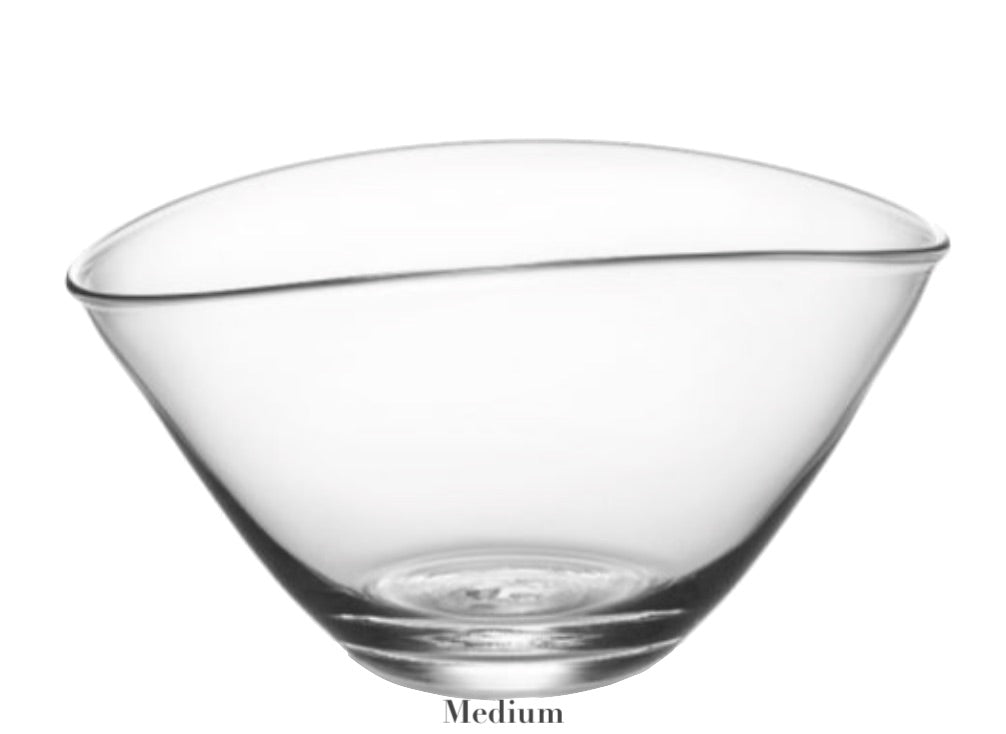 The Simon Pearce Barre Bowl from the Barre Bowl Collection is a clear glass bowl with an asymmetrical wave design, featuring a smooth, slightly curved rim labeled "Medium" at the bottom.