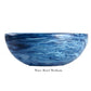 A medium-sized, round bowl from the Denim Resin Serveware Collection by Nashi Home, featuring a blue marbled wave pattern and crafted from shatter-resistant resinware. Text below reads "Wave Bowl Medium.