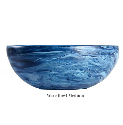 A medium-sized, round bowl from the Denim Resin Serveware Collection by Nashi Home, featuring a blue marbled wave pattern and crafted from shatter-resistant resinware. Text below reads "Wave Bowl Medium.