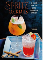 Cover of the Simon & Schuster book “Spritz Cocktails,” showcasing two spritz cocktails crafted with sparkling wine and Italian amaro, garnished and accompanied by cinnamon sticks and a blue napkin on a table.