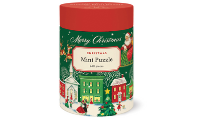 A cylindrical 240-piece Merry Christmas Mini Puzzle container with a red lid, featuring illustrations of Santa Claus, a snowy village, and a Christmas tree.