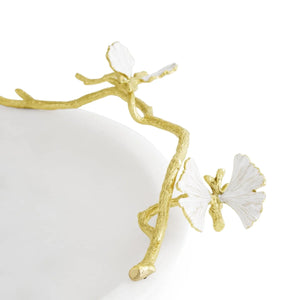 Close-up of the Michael Aram Butterfly Ginkgo Gold Trinket Dish, featuring a decorative gold branch with two white butterflies on the edge of a round marble and brass dish.