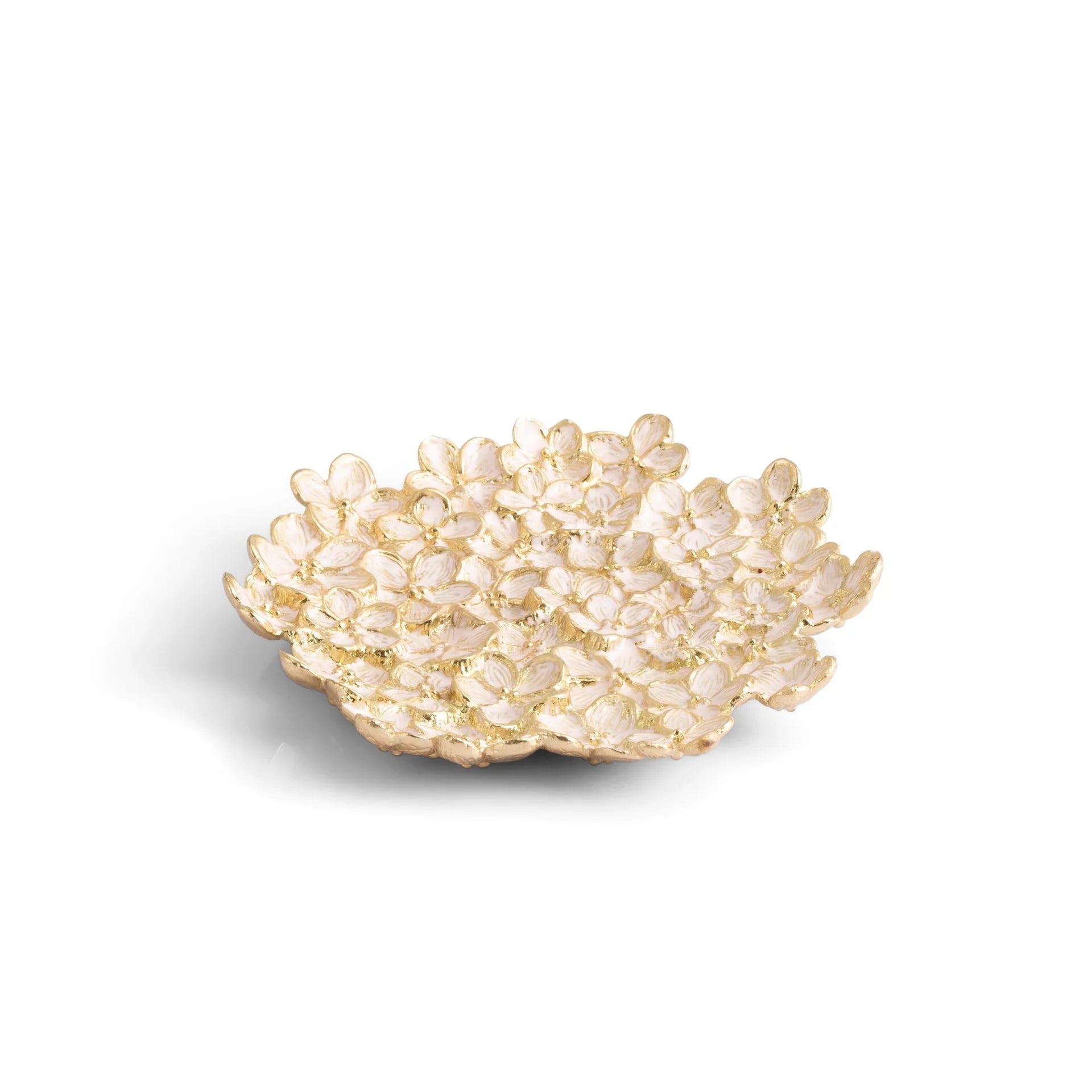 The Michael Aram Cherry Blossom Collection features a decorative bowl with a textured surface that evokes soft pink Japanese flower petals on a white background.