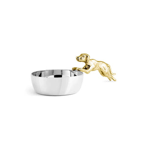 The Michael Aram Dog Scoop features a silver bowl adorned with a gold-colored dog figurine that appears to leap in or out of the vessel, set against a clean white background. Part of the whimsical Flights of Fancy Collection, this decor piece is handcrafted from hand-sculpted clay for an artistic touch.