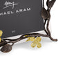 A close-up of the Michael Aram Dogwood Frame, a handcrafted photo frame with branch details and gold-toned flowers, designed to display a 5x7 inch photo.
