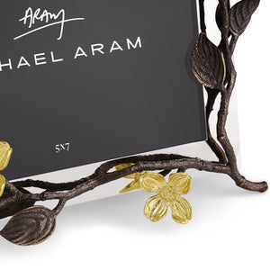 A close-up of the Michael Aram Dogwood Frame, a handcrafted photo frame with branch details and gold-toned flowers, designed to display a 5x7 inch photo.