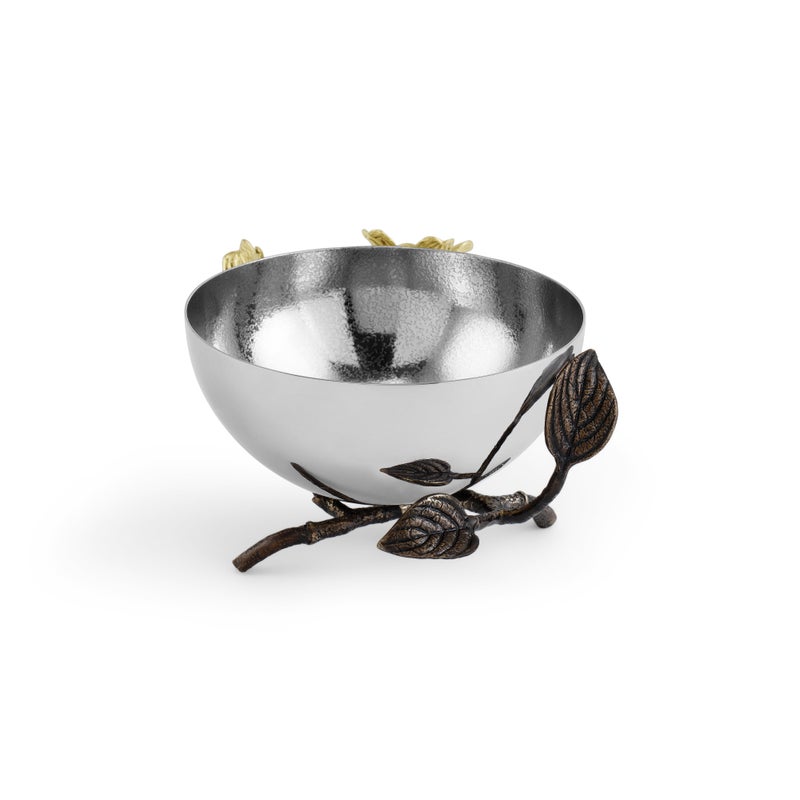 Part of the Michael Aram Dogwood Serveware Collection, this handcrafted stainless steel bowl features a textured finish and rests on a decorative branch base with leaves and gold-toned flowers for a nature-inspired look.