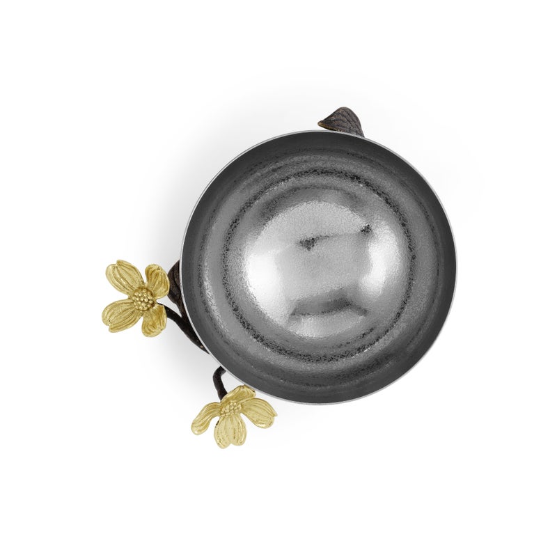 A round handcrafted stainless steel bowl with two yellow flowers and dark leaves on its edge, viewed from above on white—a striking Michael Aram piece from the Dogwood Serveware Collection.