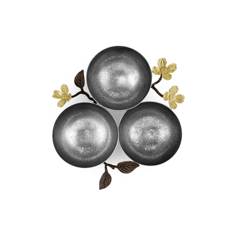 Three metallic round bowls in a triangular arrangement, adorned with gold flowers and dark leaves, highlight the nature-inspired Dogwood Serveware Collection by Michael Aram, displayed on a white background.