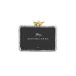From the Lovebirds Frame Collection by Michael Aram, this elegant rectangular silver picture frame features textured edges and holds a 4x6 photo. Decorated with two small gold bird figurines perched at the top, it makes a thoughtful anniversary or wedding gift—perfect for displaying cherished memories.