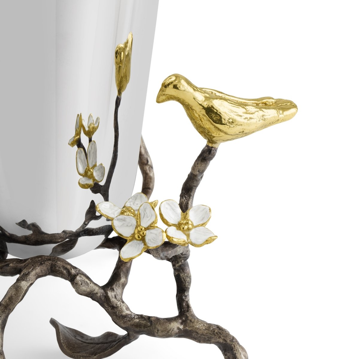 A close-up of the Michael Aram Lovebirds Vase Collection shows gold bird and white flower accents on a tree-inspired base, set against a white background.