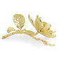 The Michael Aram Magnolia Decorative Object is a handcrafted brass sculpture featuring a gold-colored flowering branch with two leaves and a bloom—an elegant addition to your home décor collection.
