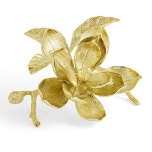 The Magnolia Decorative Object by Michael Aram is a handcrafted brass sculpture featuring a magnolia flower, leaves, and a small branch in an elegant gold finish.
