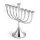 The Michael Aram Molten Menorah features nine silver candle holders, including a central elevated one. Its contemporary, handcrafted design is elegantly displayed on a white background.