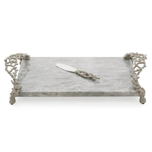 Rectangular marble serving tray with ornate metal handles and feet from the Michael Aram Ocean Reef Serveware and Barware Collection, paired with a matching cheese knife resting on the tray.
