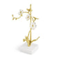 The Michael Aram Orchid Decorative Object is a handcrafted gold and white metal sculpture with three flowers on a white square base, making it a stunning decorative gift.