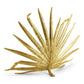 The Michael Aram Palm Decorative Fireplace Screen features a gold stylized palm leaf design with an antique gold finish and textured surface, standing upright on a white background.