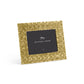 A square gold woven metal photo frame from the Palm Gold Frame Collection by Michael Aram, featuring sculpted textures and a central placeholder card displaying "Michael Aram" and a signature.