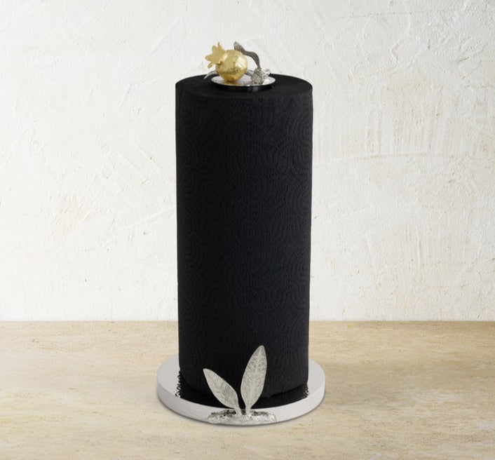 The Michael Aram Pomegranate Silver & Gold Paper Towel Holder stands upright on a round base, featuring silver and gold accents inspired by ancient pomegranate motifs.