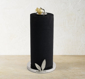 The Michael Aram Pomegranate Silver & Gold Paper Towel Holder stands upright on a round base, featuring silver and gold accents inspired by ancient pomegranate motifs.