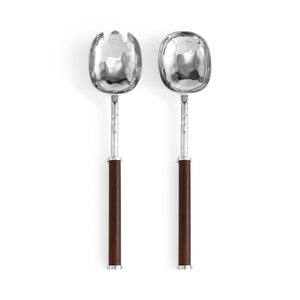 Two metal salad servers from the Reflective Serveware Collection by Michael Aram feature hammered, high-polished stainless steel heads and dark wooden handles, shown side by side on a white background.