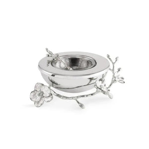 A silver bowl from the Michael Aram Silver Orchid Collection, featuring an attached decorative branch and orchid flower on one side—symbolizing purity and grace—inspired by the orchid plant, displayed against a white background.