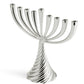 The Michael Aram Silver Twist Menorah features nine curved branches and a twisted wire base, offering a modern silver design perfect for Hanukkah candles.