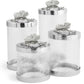 The Michael Aram White Orchid Canister Collection features elegant glass containers adorned with floral accents, highlighting exquisite luxury craftsmanship.