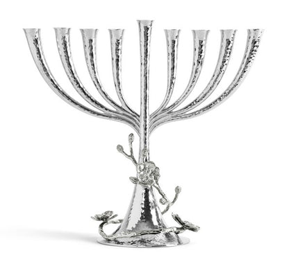 The Michael Aram White Orchid Menorah features a handcrafted nickelplate design with eight branches, a central stem, hammered texture, and elegant floral accents on the base.