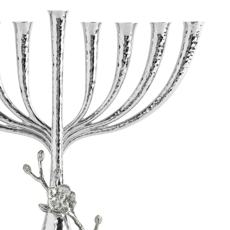 The Michael Aram White Orchid Menorah features a handcrafted, hammered silver texture and floral accents on the base, displayed against a white background—an elegant addition to your menorah collection.