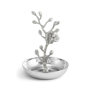 The Michael Aram White Orchid Ring Catchall features a raised, sculpted branch and flower design in the center atop a hammered silver-finished tray. Inspired by Michael Aram’s artistry, this handcrafted catchall is perfect for organizing your favorite rings and accessories.