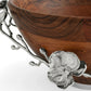 A close-up of the Michael Aram White Orchid Wood Salad Bowl showcases its rim adorned with intricate silver enamel floral and branch decorations, featuring detailed blooms and leaves.
