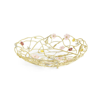 This handcrafted gold metal bowl from the Wildflower Serveware Collection by Michael Aram features an openwork design with pink and yellow flower accents, making it a charming centerpiece for any table.