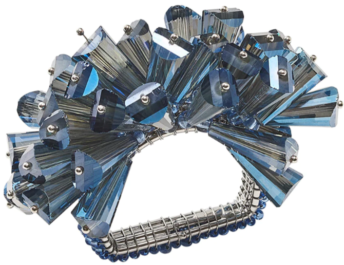 The Kim Seybert Dazzle Napkin Ring features a cluster of angular, translucent blue crystals and faceted glass beads in a spiky, decorative silver design.