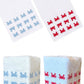 Two white linen cloths from the Haute Home Mini Crab Bath Collection, featuring blue and red crab patterns, are displayed flat and wrapped around square objects on a white background—perfect as an elegant tissue box cover.