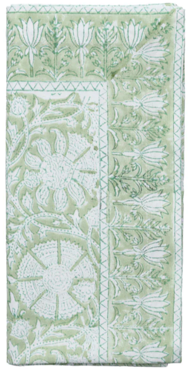 The Kim Seybert Provence Napkin Set features folded green and white textiles with a playful floral and geometric block print, perfect for pairing with a matching tablecloth or other Provence Napkins.