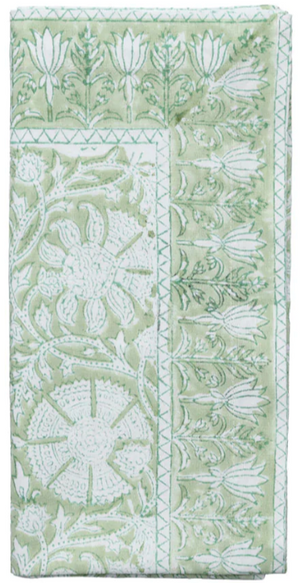 The Kim Seybert Provence Napkin Set features folded green and white textiles with a playful floral and geometric block print, perfect for pairing with a matching tablecloth or other Provence Napkins.