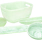 The Mint Resin Serveware Collection by Nashi Home features five light green, translucent serving bowls and trays in assorted shapes and sizes—durable, shatter-resistant accents for your home decor. Shown on a white background.