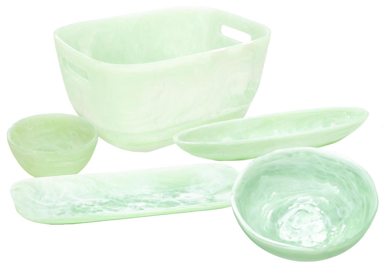 The Mint Resin Serveware Collection by Nashi Home features five light green, translucent serving bowls and trays in assorted shapes and sizes—durable, shatter-resistant accents for your home decor. Shown on a white background.