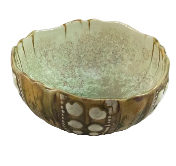 The Sea Urchin Bowl Collection by AE Ceramics features hand-molded ceramic bowls with scalloped edges, a greenish-beige glaze, and circular patterns—ideal for anyone seeking unique tabletop accessories.